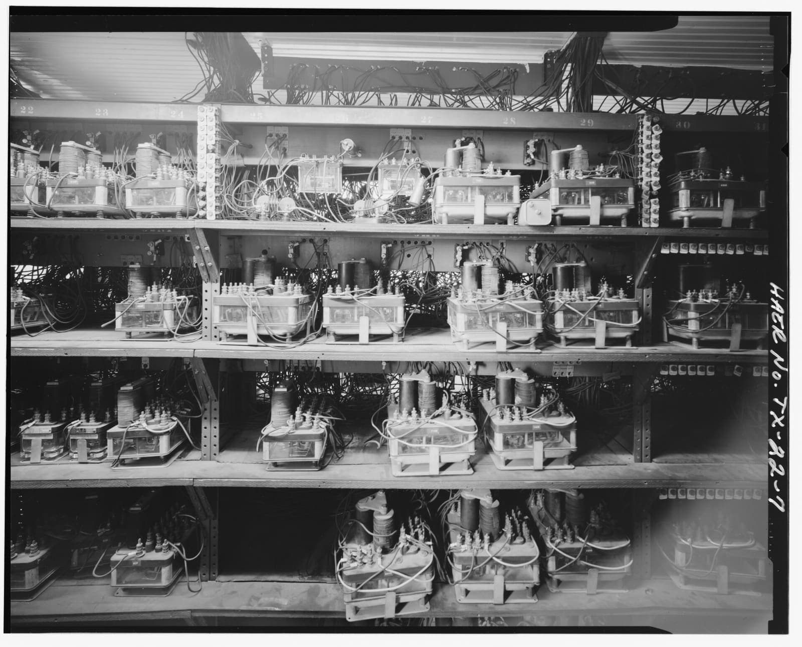 Rows of electromechanical relay equipment in a railway signaling room