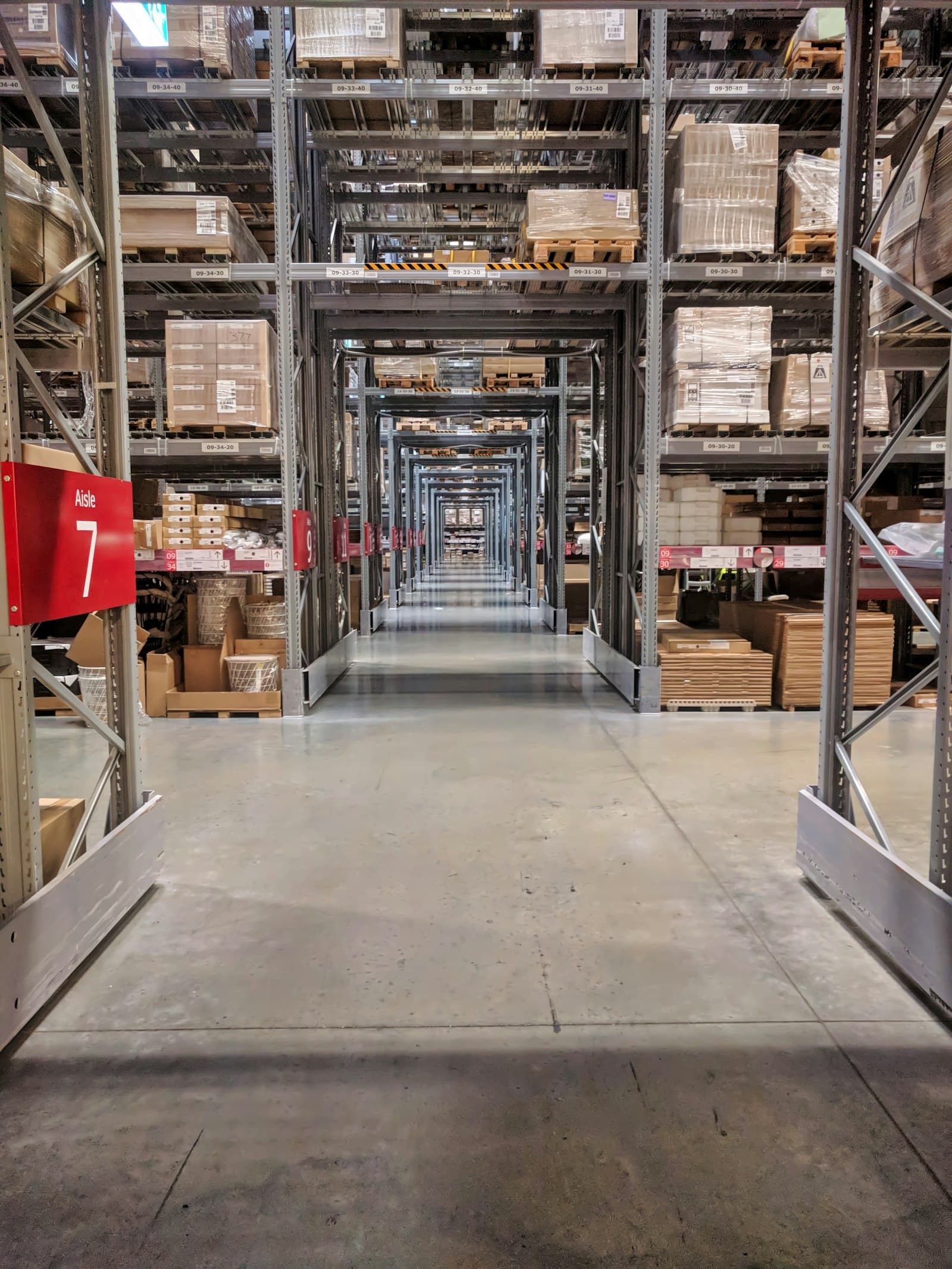 Warehouse aisle representing coordinated procurement logistics